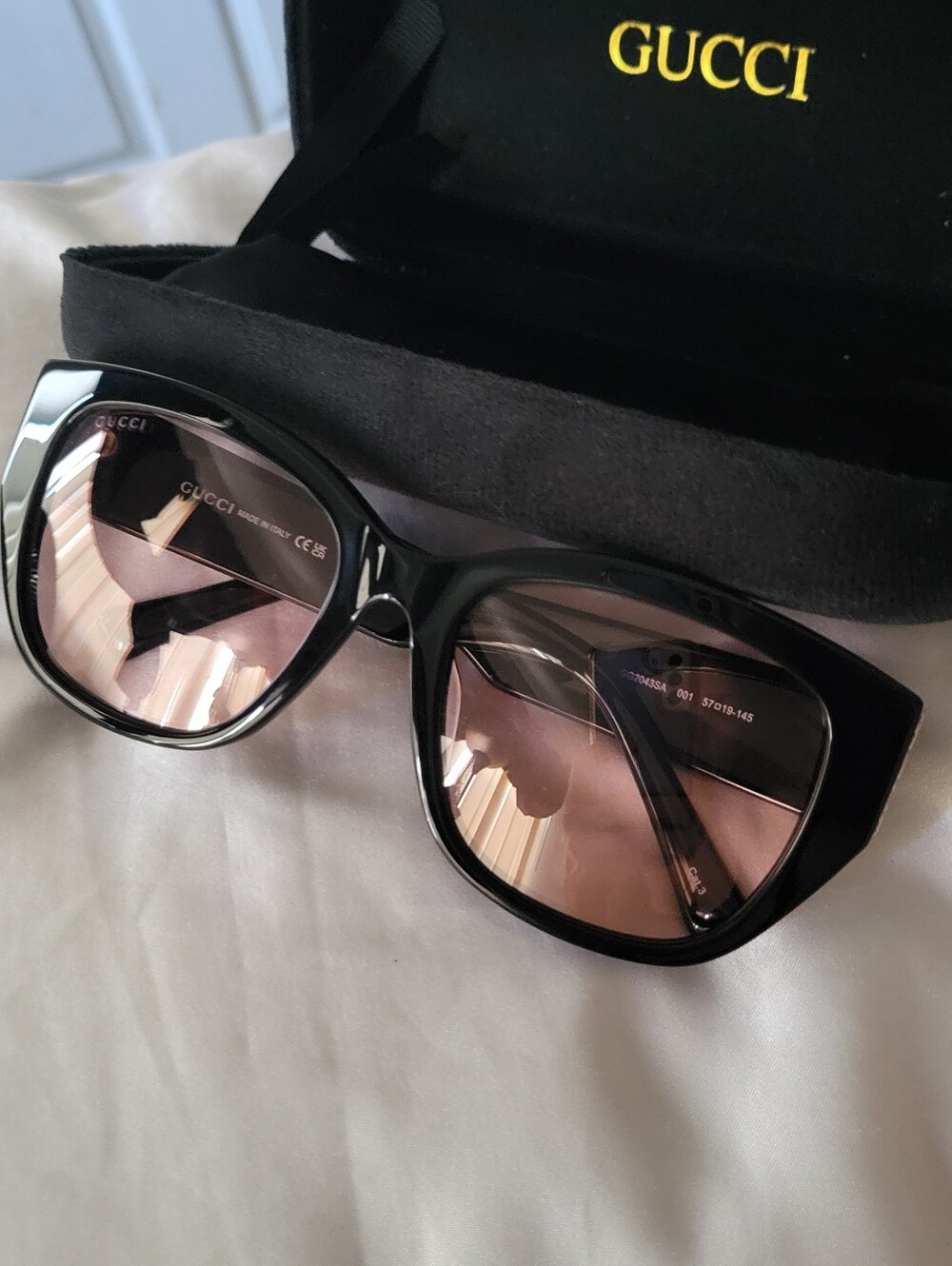 Black Frame Sunglasses with Pink Lenses and Golden Logo